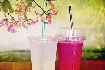 Lemon juice and lasberry juice on blur background