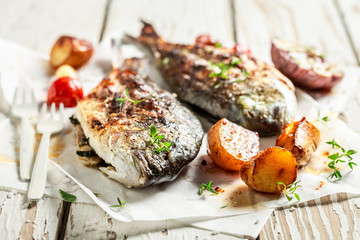 Potatoes and sea bream with cherry tomatoes