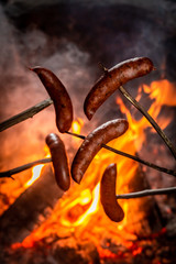 Fototapeta premium Hot and spicy sausage roasted on the bonfire