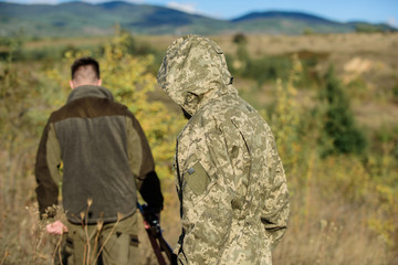 Activity for brutal men. Hunters poachers looking for victim. Poachers with rifles in nature environment. Illegal hunting. Hunters brutal poachers. Forbidden hunting. Breaking law. Poaching concept