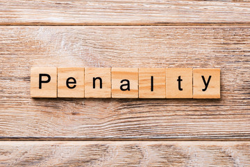 PENALTY word written on wood block. PENALTY text on wooden table for your desing, concept