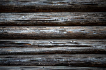 Dark old log wood wall of house
