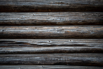 Fototapeta premium Dark old log wood wall of house