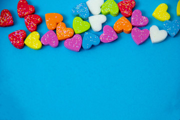 Fototapeta na wymiar A multicolored hearts shape on blue sky background, image using for valentine ‘s day signs and lovely sweet concept