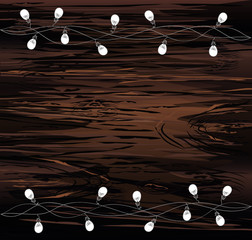 A set of warm light bulb garlands, holiday decorations. The lamps. Glowing Christmas lights. Vector on wooden background.