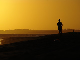 Fototapeta na wymiar Man at the beach on sunset