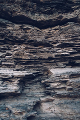 Surface of an stone wall. Black Stone background. Rock texture. Rock pile background