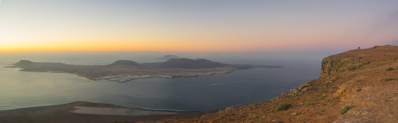 Panoramic view from the Mirador del Rio in Lanzarote during sunset with the island of La Graciosa