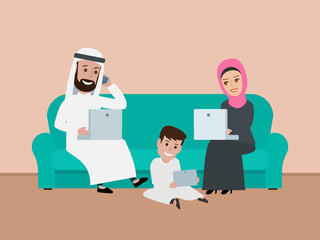arab family sitting on the sofa and using gadgets laptop smartphone tablet