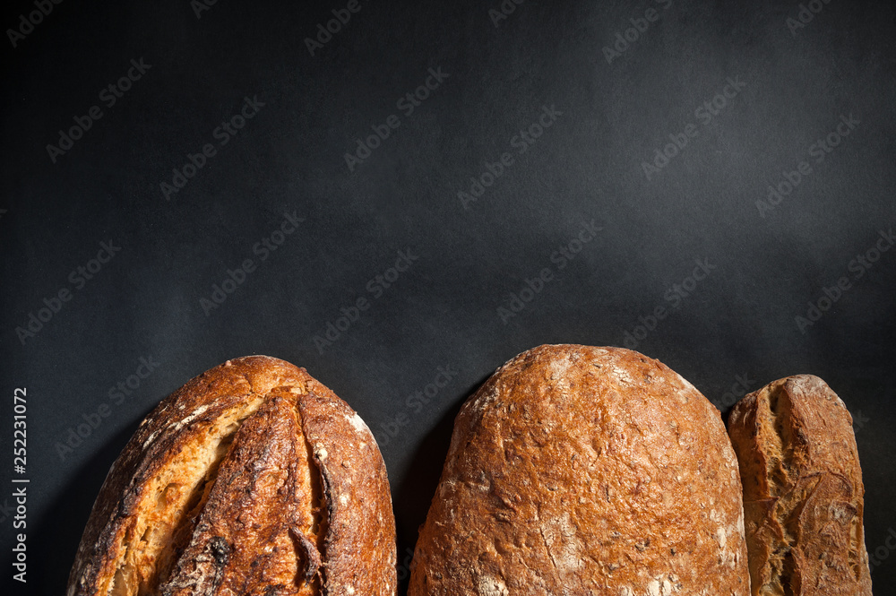 Wall mural grain bread on dark