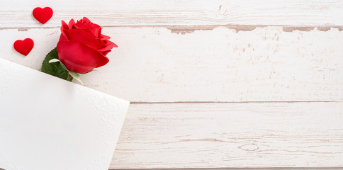 Greeting concept - Beautiful roses and hearts shape with white empty card isolated on a bright wooden table, copy space, flat lay, top view, mock up