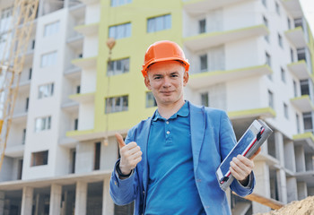 Architect or builder standing at a building site