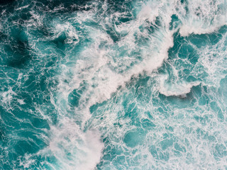 Aerial top down shot of ocean or sea surf during the storm - obrazy, fototapety, plakaty