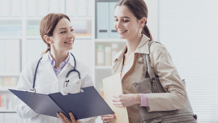 Doctor showing medical records to a patient