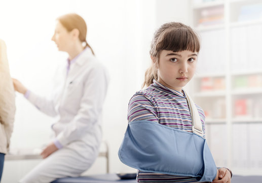 Girl with broken arm and arm brace in the doctor's office