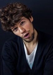 Obraz premium Curly man portrait on dark studio background