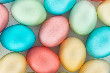 Fototapeta na wymiar top view of pastel easter eggs on grey
