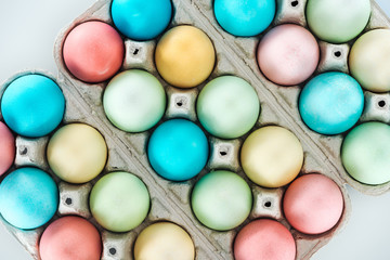 top view of colorful easter eggs in paper containers