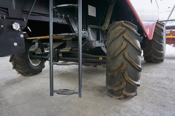 Plakat large tires with a large tread on a new agricultural tractor after assembly at the plant on a sunny day