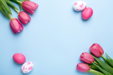Naklejka na ściany i meble Pink flowers tulips and easter eggs on a blue background
