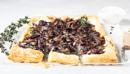 Mushroom tart, puff pastry pie with cream cheese, mushrooms, onion and thyme. Light concrete...