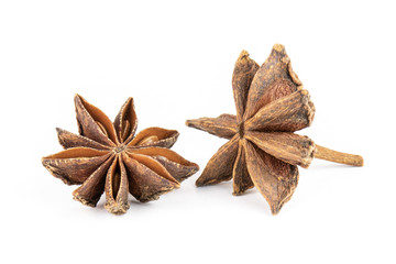 Group of two whole dry brown star anise fruit isolated on white background