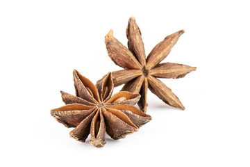Closeup of two whole dry brown star anise fruit isolated on white background