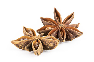 Group of two whole dry brown star anise fruit one is like a butterfly isolated on white background