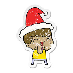 distressed sticker cartoon of a happy man wearing santa hat