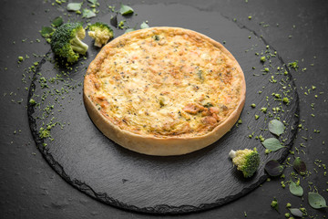 Traditional quiche pie with broccoli, salmon and cheese.