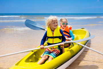 Fototapeta na wymiar Kids kayaking in ocean. Children in kayak in tropical sea