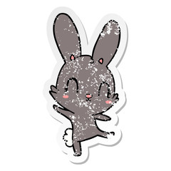 distressed sticker of a cute cartoon rabbit dancing