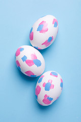 Easter eggs with watercolor brushstrokes on a blue background