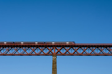 train on the bridge on blue sky background