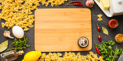 pasta, farfalle and sauce (set of ingredients). food background. copy space