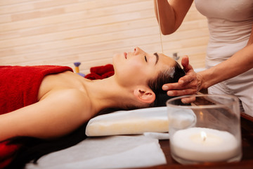 Appealing fit woman being naked during Ayurveda treatment