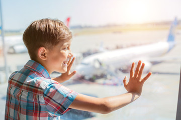 Boy looking at planes in the airport