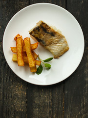 Fish and chips (white fish with vegetables, potatoes, portion). food background. copy space
