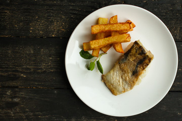 Fish and chips (white fish with vegetables, potatoes, portion). food background. copy space