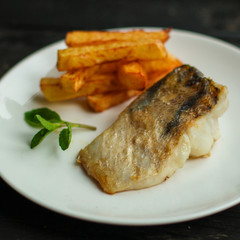 Fish and chips (white fish with vegetables, potatoes, portion). food background. copy space