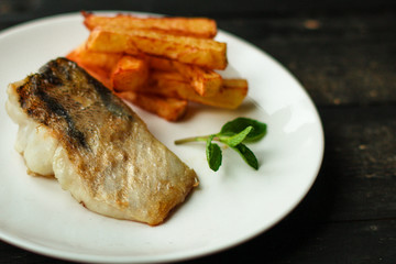 Fish and chips (white fish with vegetables, potatoes, portion). food background. copy space