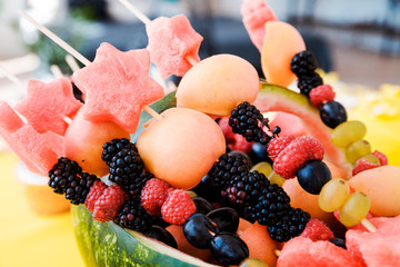 Watermelon basket filled with fruit. Horizontal photo