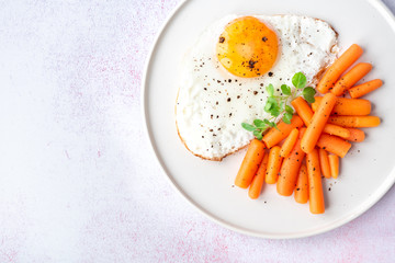 Fried eggs and vegetables top view, healthy breakfast. Copy space.
