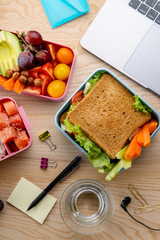 Flat lay with healthy lunch dishes variety: sandwich, salad and fruit snacks. Daily office or school lunch concept