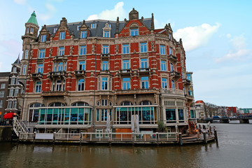 Fototapeta na wymiar Medieval building along the river Amstel in Amsterdam Netherlands