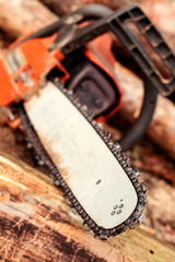 Professional chainsaw blade cutting log of wood. Heavy duty wood cutting equipment.