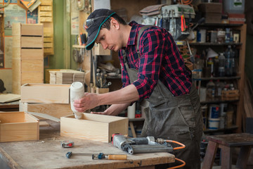 Worker making the wood box. Profession, carpentry and woodwork concept.