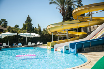 Water slide with a pool by the sea on the background of nature.