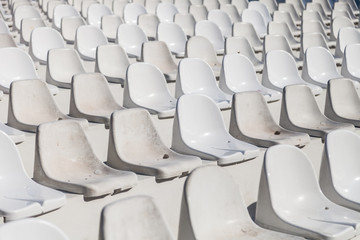 rows of white chairs in the amphitheater. Stadium, circus, event, theater. Selective focus