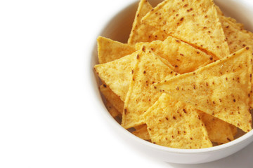 Corn Totillas chips in a bowl isolated on white background. Mexican food also called Nachos